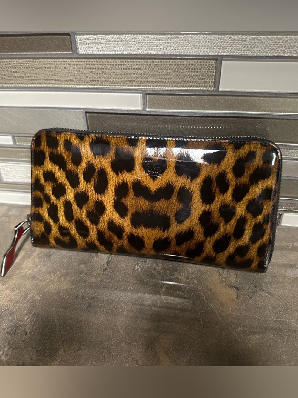 Christian Louboutin Panettone leopard-print patent leather wallet.
